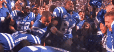 A Football Player Wearing A Number 84 Jersey Is Surrounded By Other Players GIF