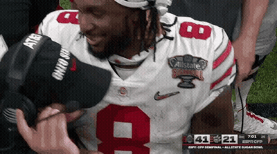 A Football Player Wearing A Number 9 Jersey Is Kneeling Down GIF