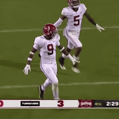 A Football Player Wearing A Number 9 Jersey Stands Next To A Player Wearing A Number 5 Jersey . GIF