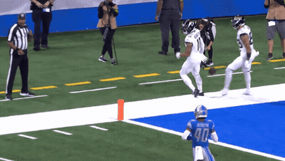 A Football Player Wearing A Number 90 Jersey Is Running On The Field GIF