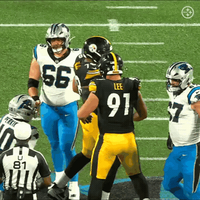 A Football Player Wearing A Number 91 Jersey Talks To Another Player GIF