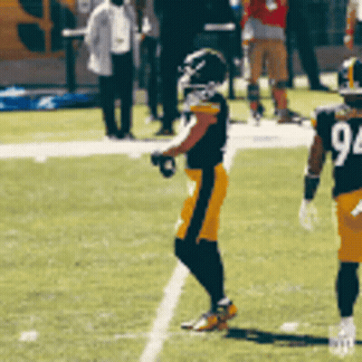 A Football Player Wearing A Number 94 Jersey Stands On The Field GIF