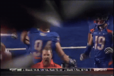 A Football Player Wearing A Number 94 Jersey Talks To Another Player GIF
