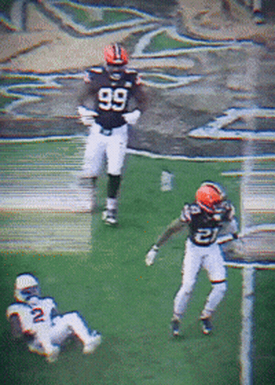 A Football Player Wearing A Number 99 Jersey Runs On The Field GIF