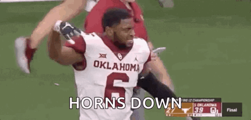 A Football Player Wearing A Oklahoma Jersey Is Running On A Field . GIF
