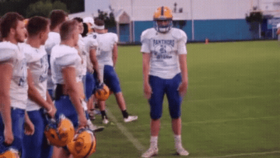A Football Player Wearing A Panthers Jersey Stands On The Field GIF