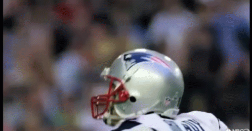 A Football Player Wearing A Patriots Helmet Stands On A Field GIF