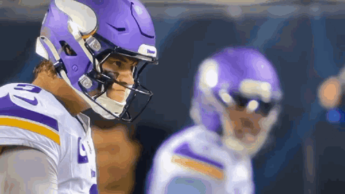 A Football Player Wearing A Purple Helmet Has The Number 10 On His Shirt GIF