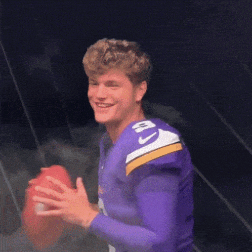 A Football Player Wearing A Purple Jersey With The Number 10 On It GIF