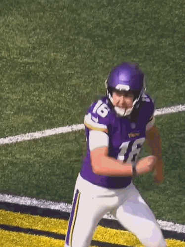 A Football Player Wearing A Purple Jersey With The Number 16 On It GIF
