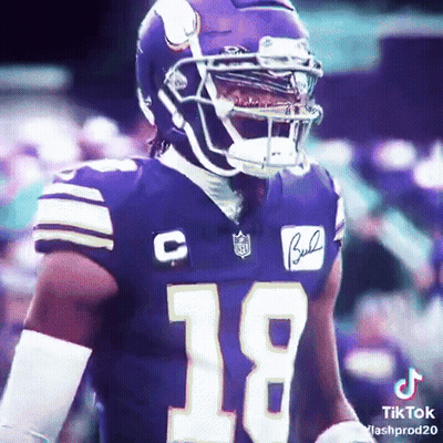 A Football Player Wearing A Purple Jersey With The Number 18 GIF