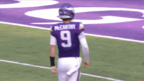 A Football Player Wearing A Purple Jersey With The Number 9 On The Back GIF