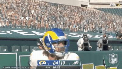 A Football Player Wearing A Rams Helmet Stands In Front Of A Crowd GIF