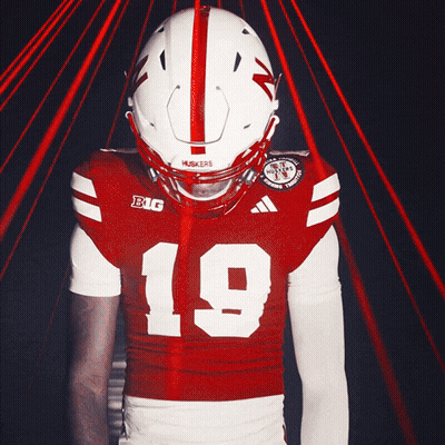 A Football Player Wearing A Red And White Jersey With The Number 19 On It GIF