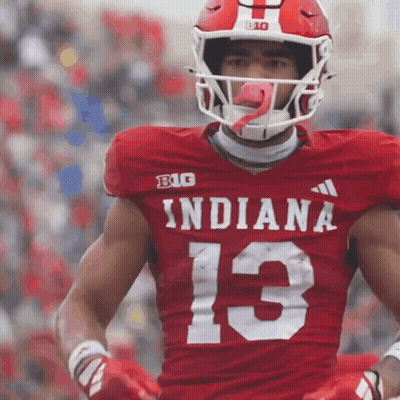 A Football Player Wearing A Red Indiana Jersey With The Number 13 On It GIF