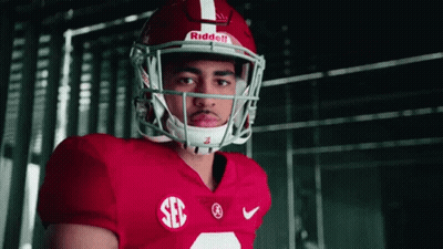 A Football Player Wearing A Red Jersey And A Riddell Helmet Looks At The Camera GIF