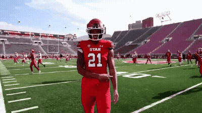 A Football Player Wearing A Red Jersey With The Number 21 GIF