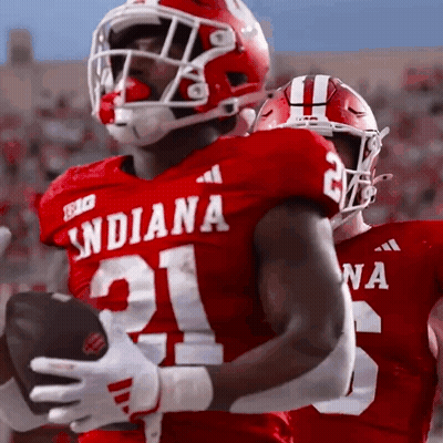A Football Player Wearing A Red Jersey With The Number 21 On It GIF