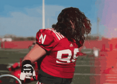 A Football Player Wearing A Red Jersey With The Number 25 On It GIF