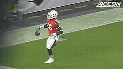 A Football Player Wearing A Red Jersey With The Number 26 On It GIF