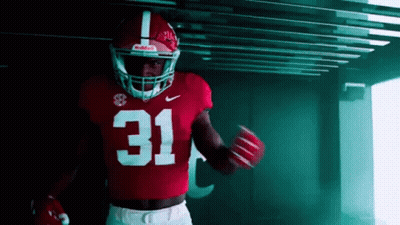 A Football Player Wearing A Red Jersey With The Number 31 GIF