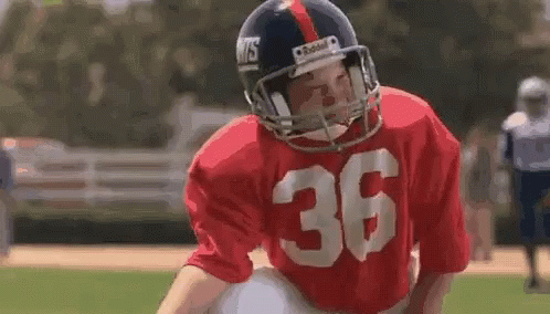A Football Player Wearing A Red Jersey With The Number 36 GIF