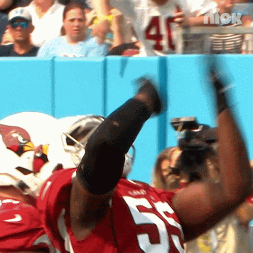 A Football Player Wearing A Red Jersey With The Number 57 On It GIF