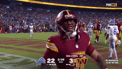 A Football Player Wearing A Red Jersey With The Word Commanders On It GIF