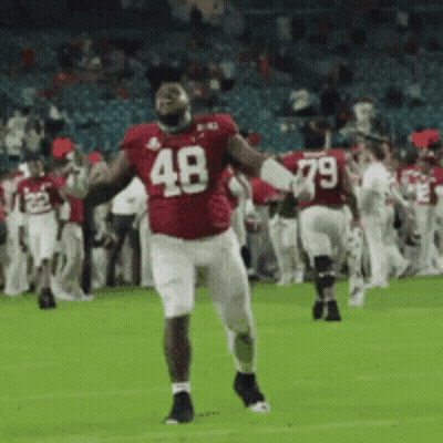 A Football Player Wearing A Red Uniform With The Number 48 On It GIF