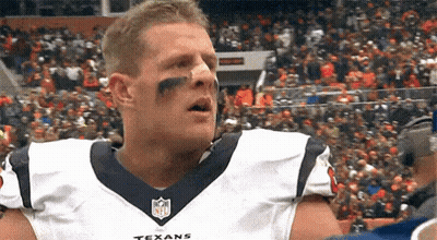 A Football Player Wearing A Texans Jersey Is Standing In Front Of A Crowd Of People . GIF