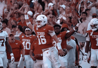 A Football Player Wearing A Texas 16 Jersey Holds Up His Hand GIF