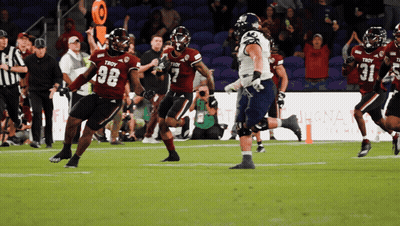 A Football Player Wearing A Troy Jersey Runs With The Ball GIF