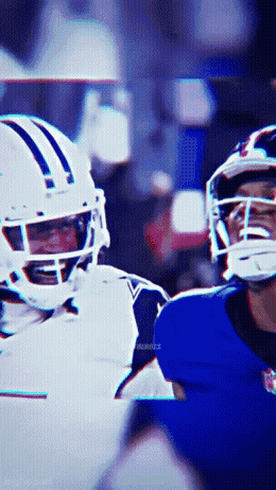 A Football Player Wearing A White Helmet Is Talking To Another Player Wearing A Blue Helmet GIF