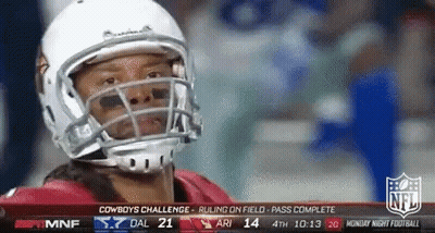 A Football Player Wearing A White Helmet Looks At The Camera GIF