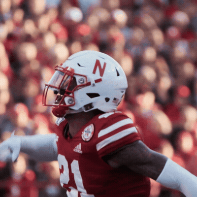 A Football Player Wearing A White Helmet With A Red Letter N On It GIF