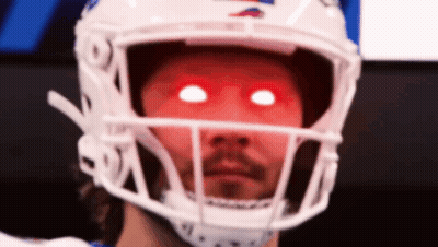 A Football Player Wearing A White Helmet With Red Eyes . GIF