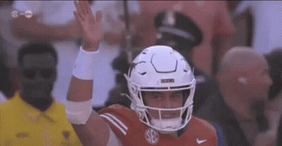 A Football Player Wearing A White Helmet With The Letter S On It GIF