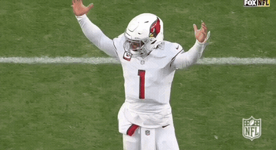 A Football Player Wearing A White Jersey With The Number 1 On It Is Running On The Field . GIF