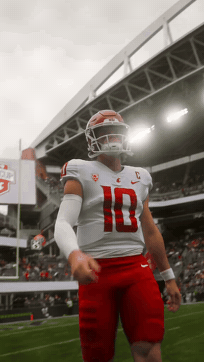 A Football Player Wearing A White Jersey With The Number 10 On It GIF