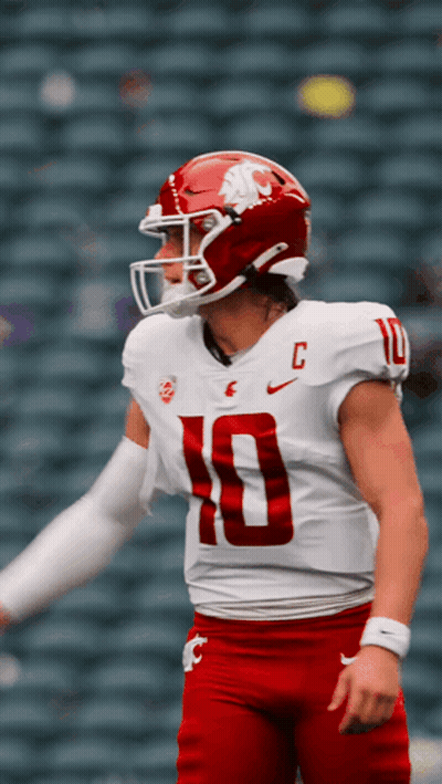 A Football Player Wearing A White Jersey With The Number 10 On The Front GIF