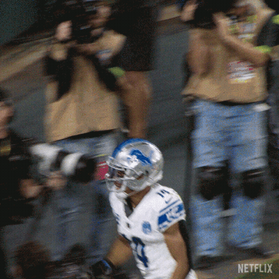 A Football Player Wearing A White Jersey With The Number 17 On It GIF