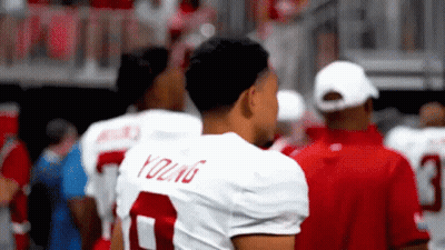 A Football Player Wearing A White Jersey With The Number 7 On It GIF