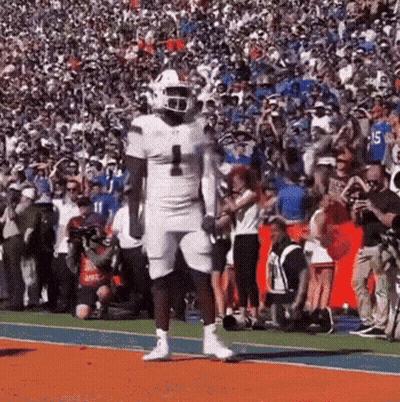 A Football Player Wearing A White Uniform With The Number 1 On It GIF