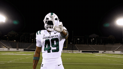 A Football Player Wearing A White Uniform With The Number 49 On It GIF