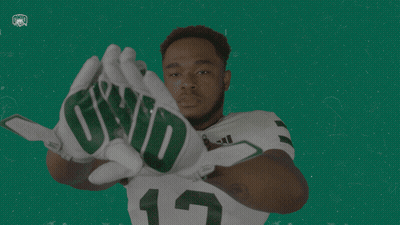 A Football Player Wearing Gloves That Say Qwd GIF