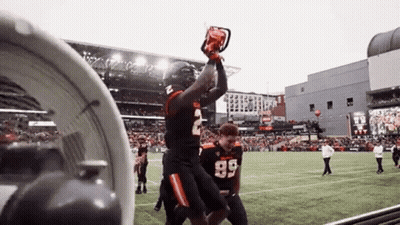 A Football Player Wearing Number 2 Is Holding A Chainsaw In His Hand GIF