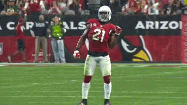 A Football Player Wearing Number 21 Stands On The Field GIF