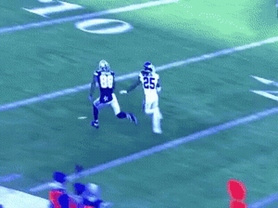 A Football Player Wearing Number 33 Is Trying To Catch A Pass GIF