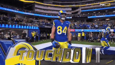 A Football Player Wearing Number 84 Stands On The Field GIF