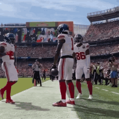 A Football Player Wearing Number 86 Stands On The Sidelines GIF